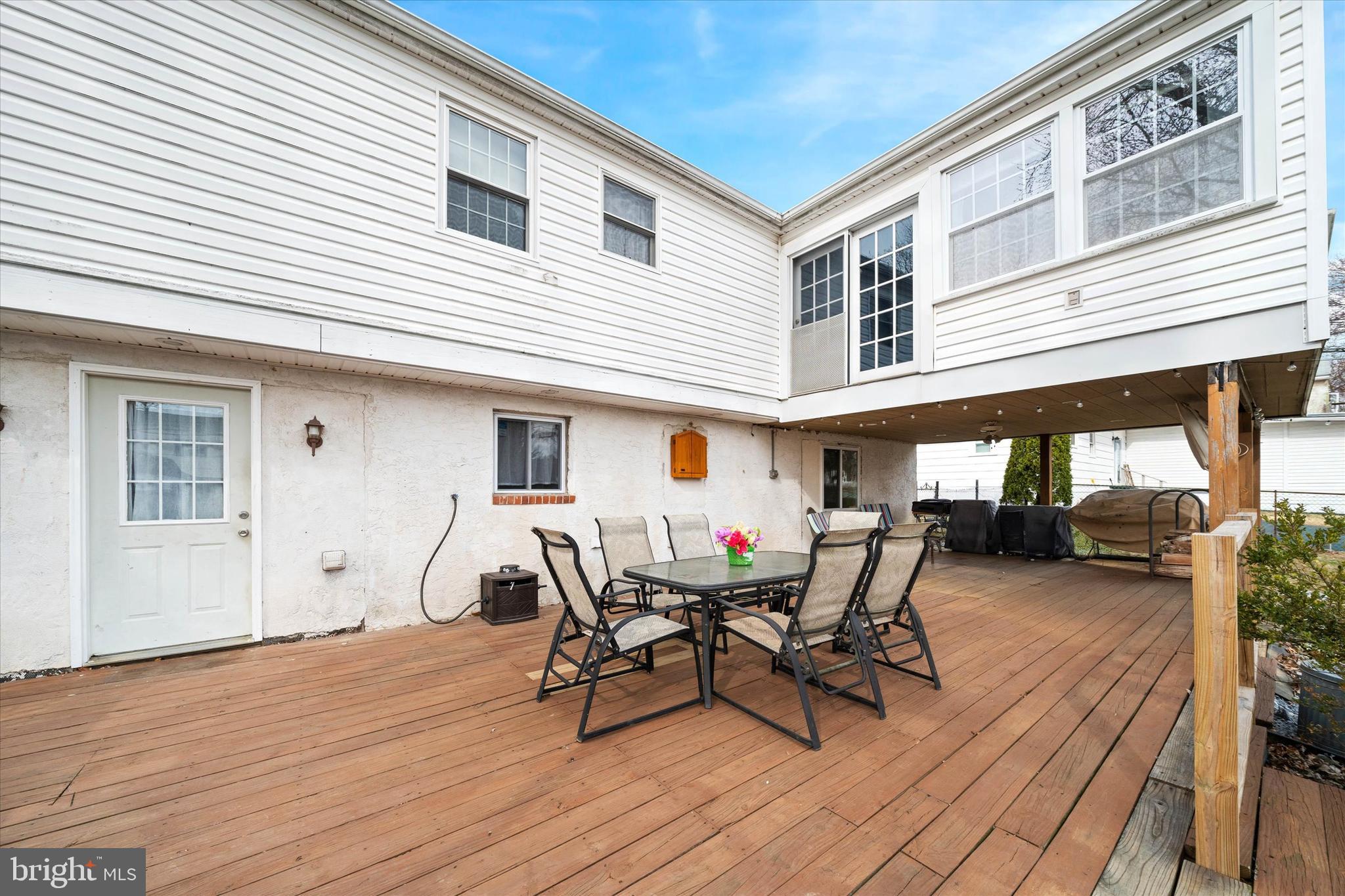 1331 Cherry Tree Road Aston, PA 19014 - Photo 36 of 40 a view of a patio with table and chairs with wooden floor and fence