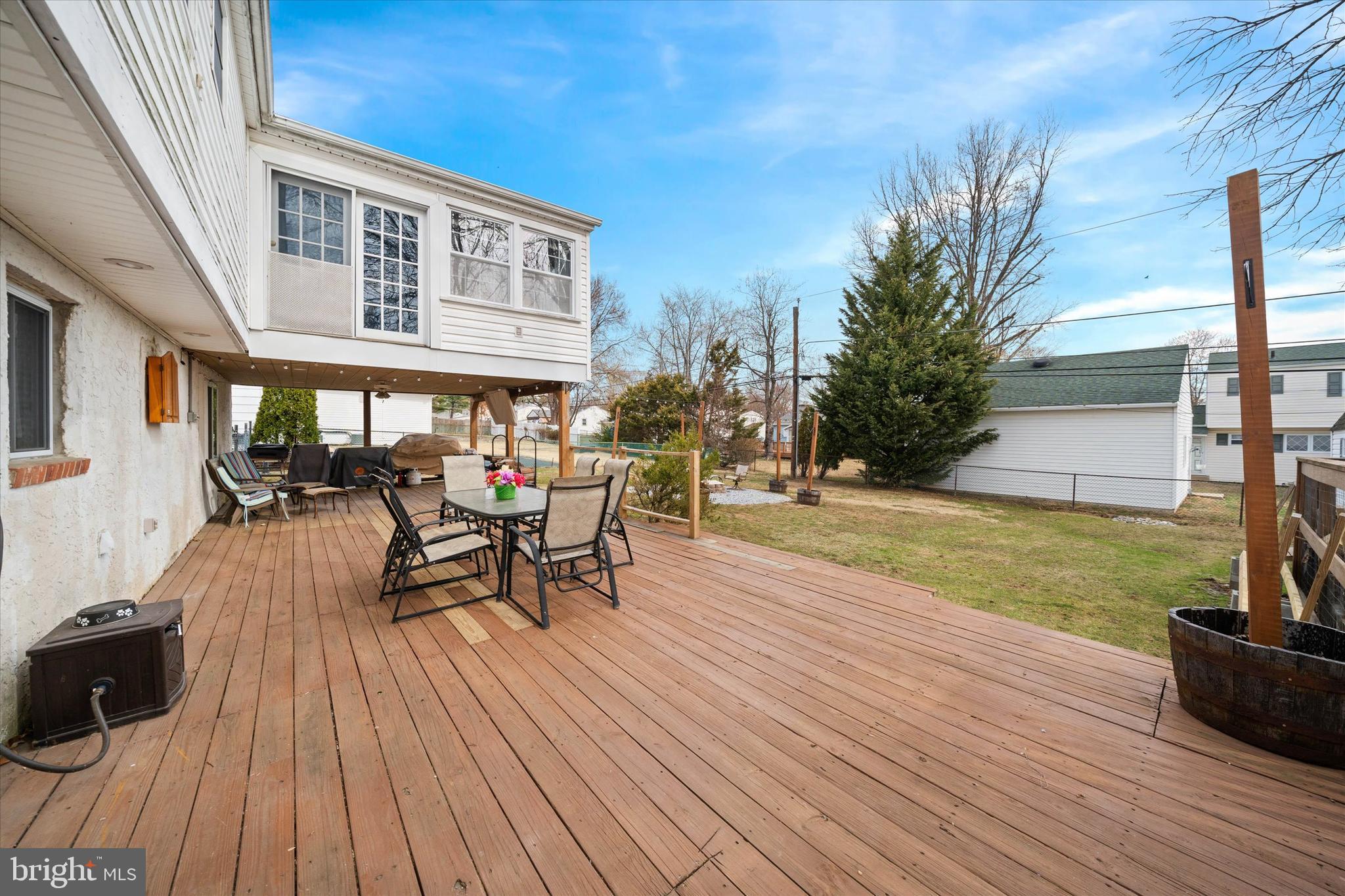 1331 Cherry Tree Road Aston, PA 19014 - Photo 37 of 40 a view of a patio with dining table and chairs with wooden floor and fence