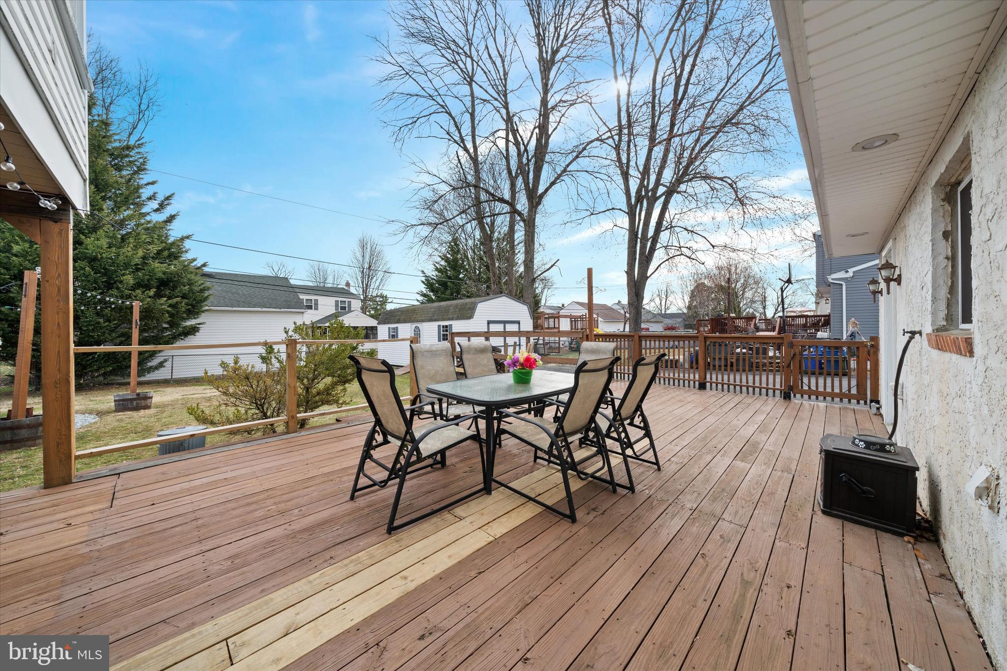 1331 Cherry Tree Road Aston, PA 19014 - Photo 39 of 40 a view of a roof deck with table and chairs a barbeque with wooden floor and fence