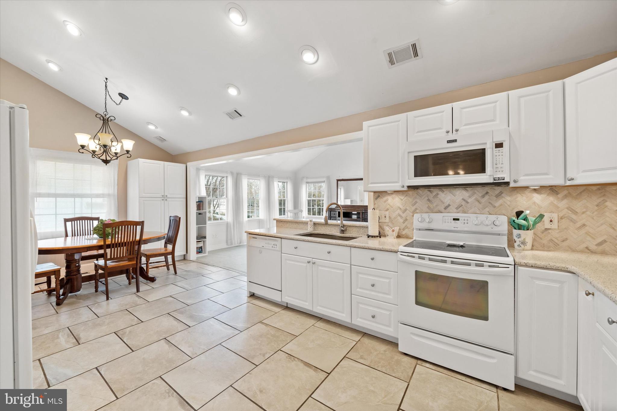 1331 Cherry Tree Road Aston, PA 19014 - Photo 6 of 40 a kitchen with cabinets appliances and a dining table