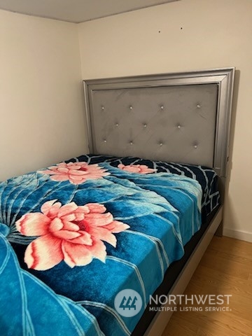 3612 Northeast 4th Street, Unit 18 Renton, WA 98056 - Photo 13 of 16 a bed sitting in a bedroom next to a window