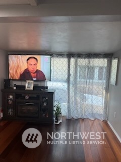 3612 Northeast 4th Street, Unit 18 Renton, WA 98056 - Photo 8 of 16 a living room with furniture and a flat screen tv