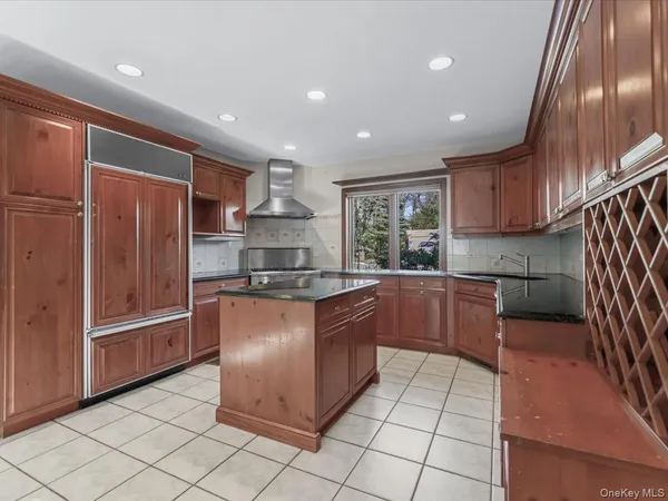 a kitchen with stainless steel appliances granite countertop a refrigerator and a sink