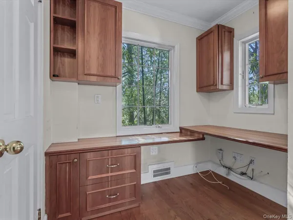 a kitchen with granite countertop cabinets stainless steel appliances and a window