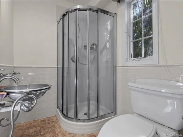 a bathroom with a toilet and shower