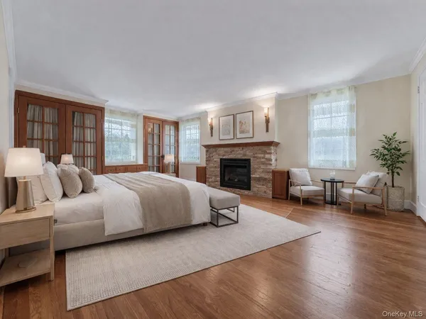 a spacious bedroom with a bed and a fireplace