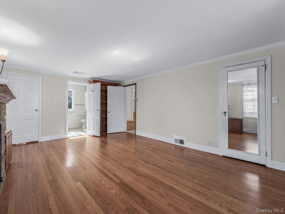 2 Amherst Road Great Neck, NY 11021 - Photo 23 of 45 a view of an empty room with wooden floor and a window