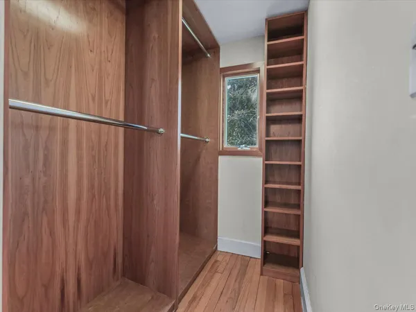 a view of walk in closet with empty room