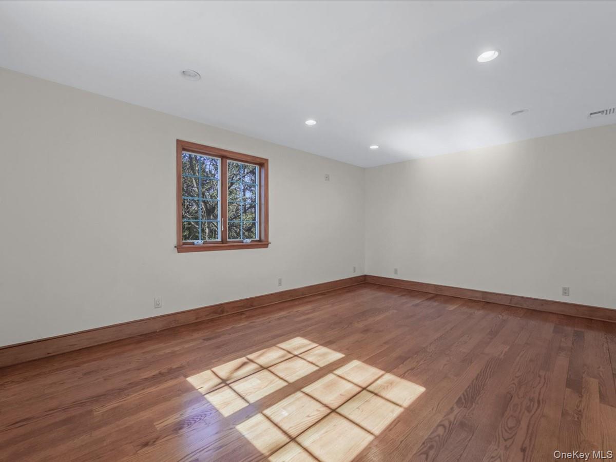 2 Amherst Road Great Neck, NY 11021 - Photo 30 of 45 a view of an empty room with wooden floor and a window