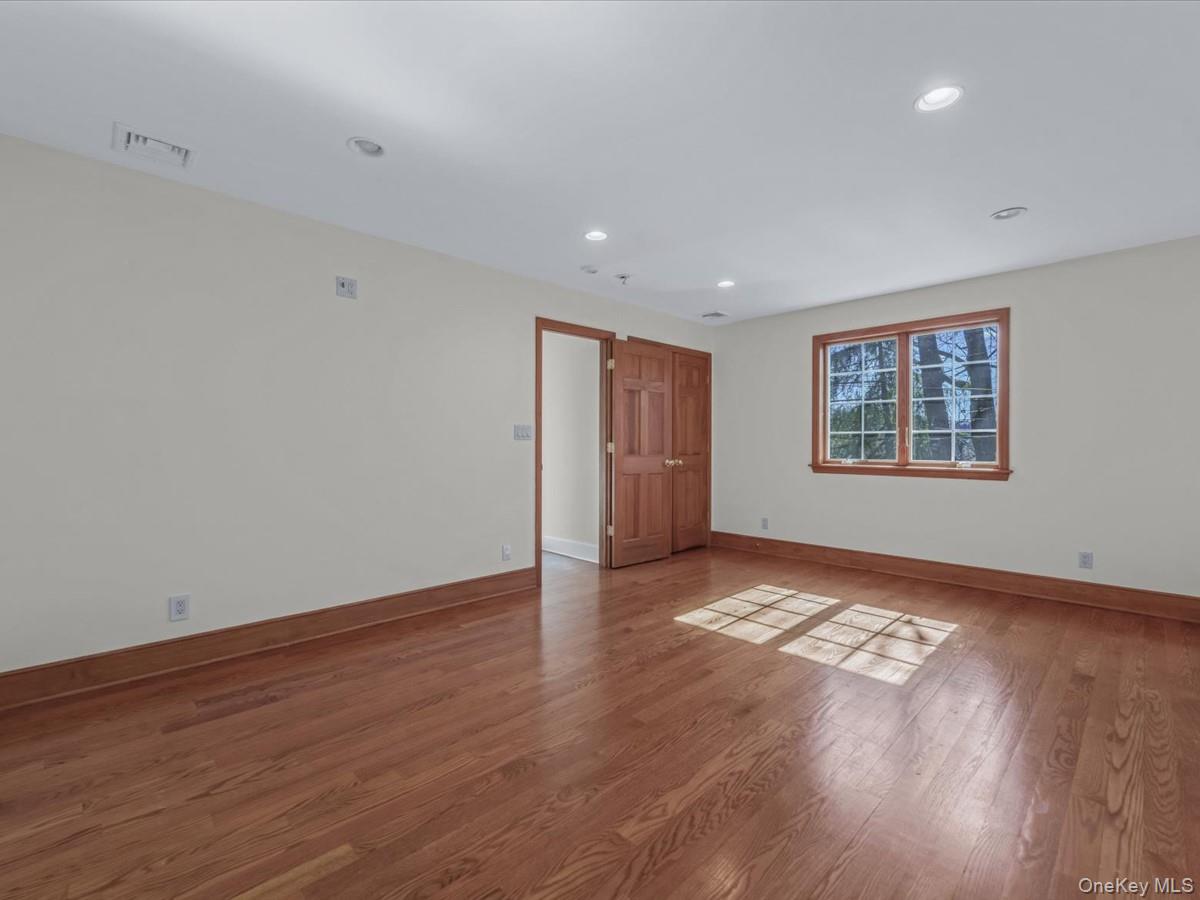 2 Amherst Road Great Neck, NY 11021 - Photo 31 of 45 a view of an empty room with wooden floor and a window