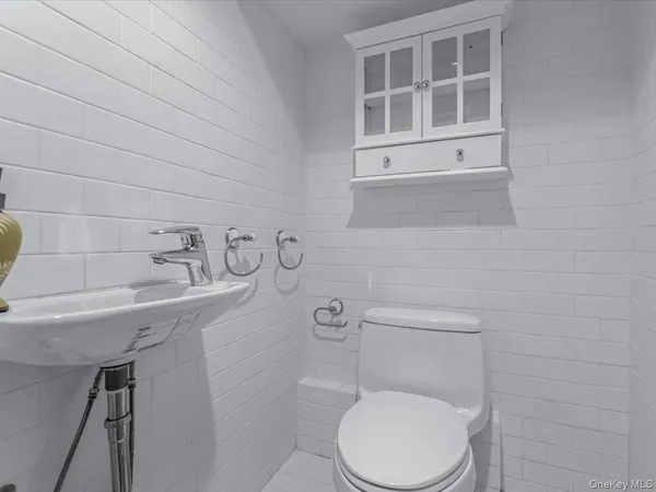 a white toilet sitting next to a sink