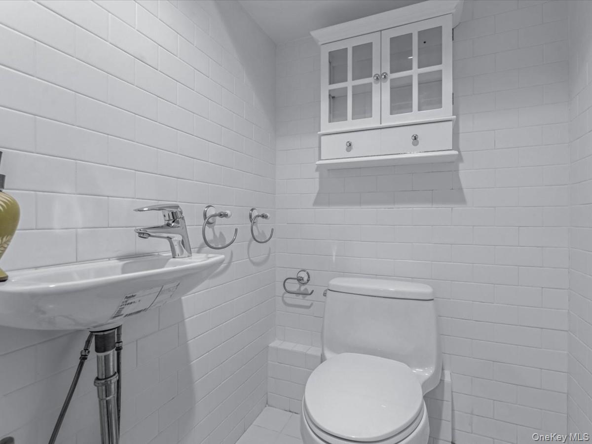 2 Amherst Road Great Neck, NY 11021 - Photo 36 of 45 a white toilet sitting next to a sink