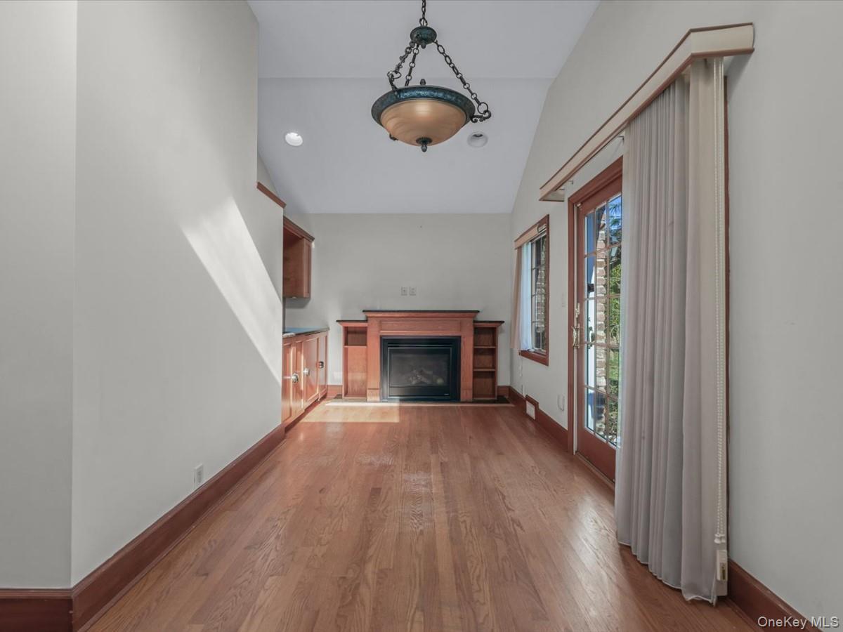 2 Amherst Road Great Neck, NY 11021 - Photo 8 of 45 a view of an empty room with wooden floor fireplace and a window