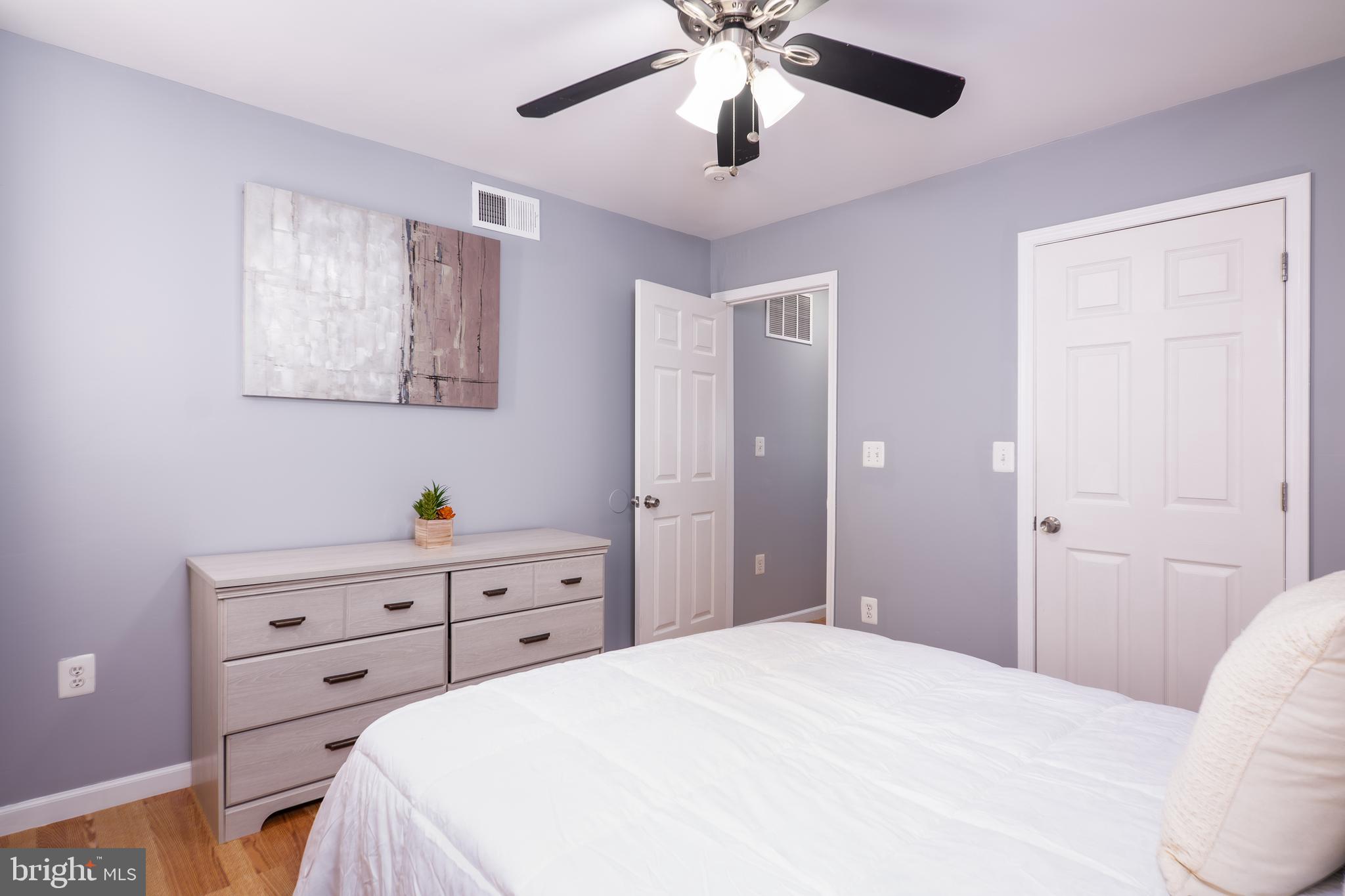 1247 Carroll Street Baltimore, MD 21230 - Photo 16 of 24 a bedroom with a bed and a chandelier