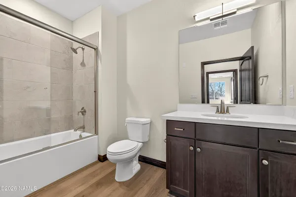 a bathroom with a sink toilet a mirror and shower