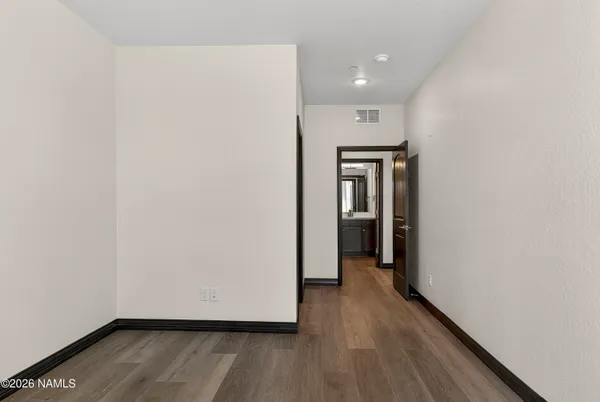 a view of hallway with wooden floor