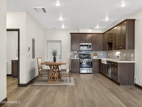 a large kitchen with a table and chairs