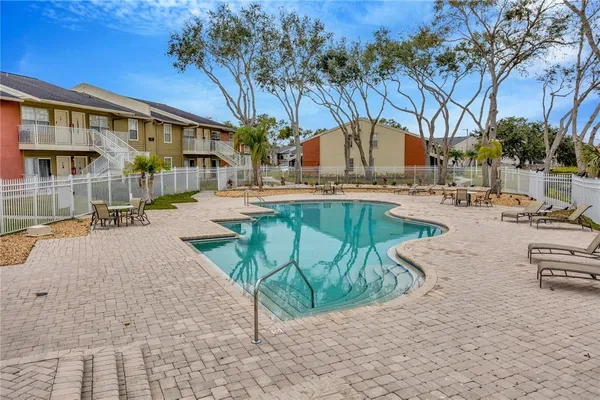 a view of a house with backyard patio and swimming pool