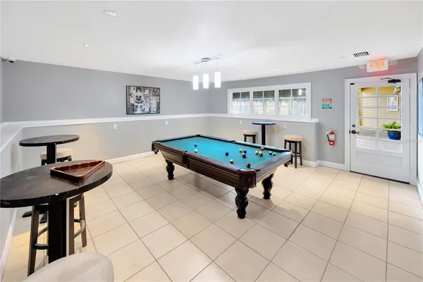 a view of a room with gym equipment and floor to ceiling window