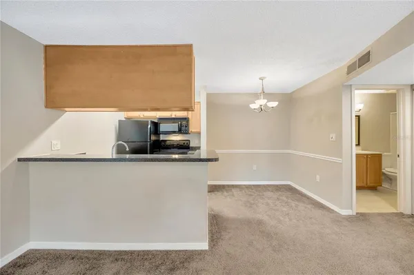 a view of a kitchen with a sink and a window