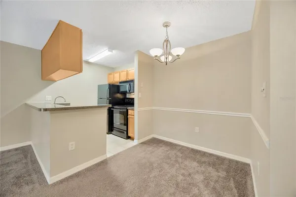 a kitchen with granite countertop a sink and stainless steel appliances