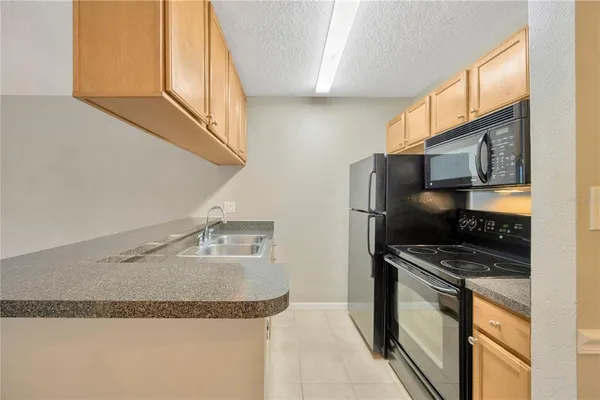a kitchen with wooden cabinets and a stove top oven