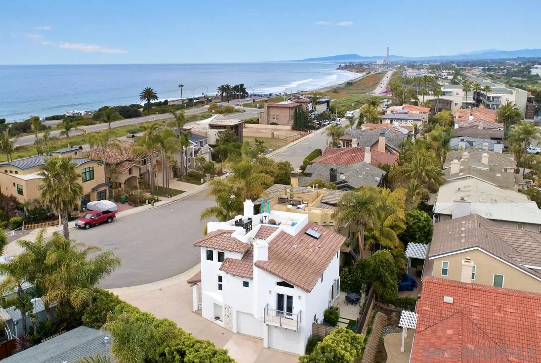 6512 Surfside Lane Carlsbad, CA 92011 - Photo 1 of 26 an aerial view of a building with an outdoor space and seating area