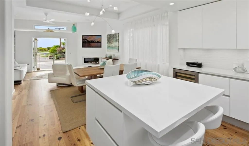 6512 Surfside Lane Carlsbad, CA 92011 - Photo 13 of 26 a kitchen with a sink a stove and chairs