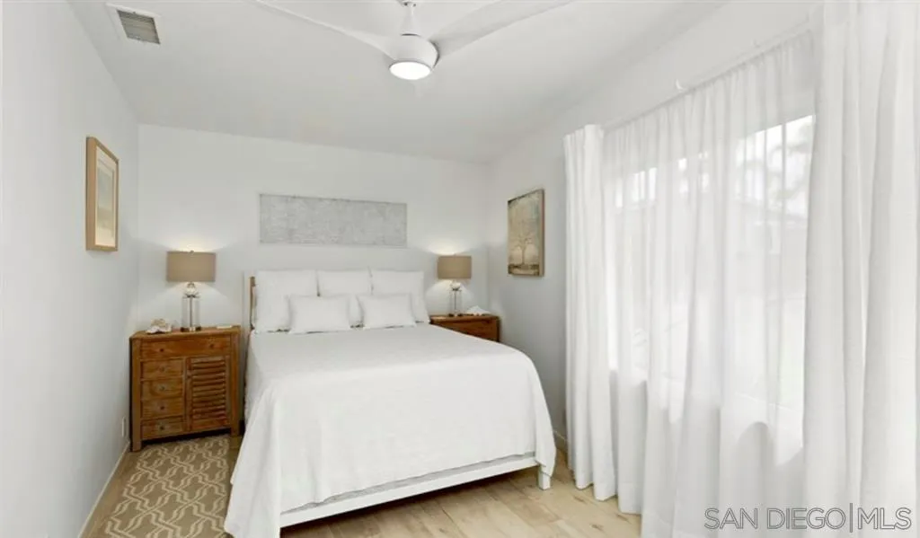 6512 Surfside Lane Carlsbad, CA 92011 - Photo 20 of 26 a bedroom with a bed and a cabinets