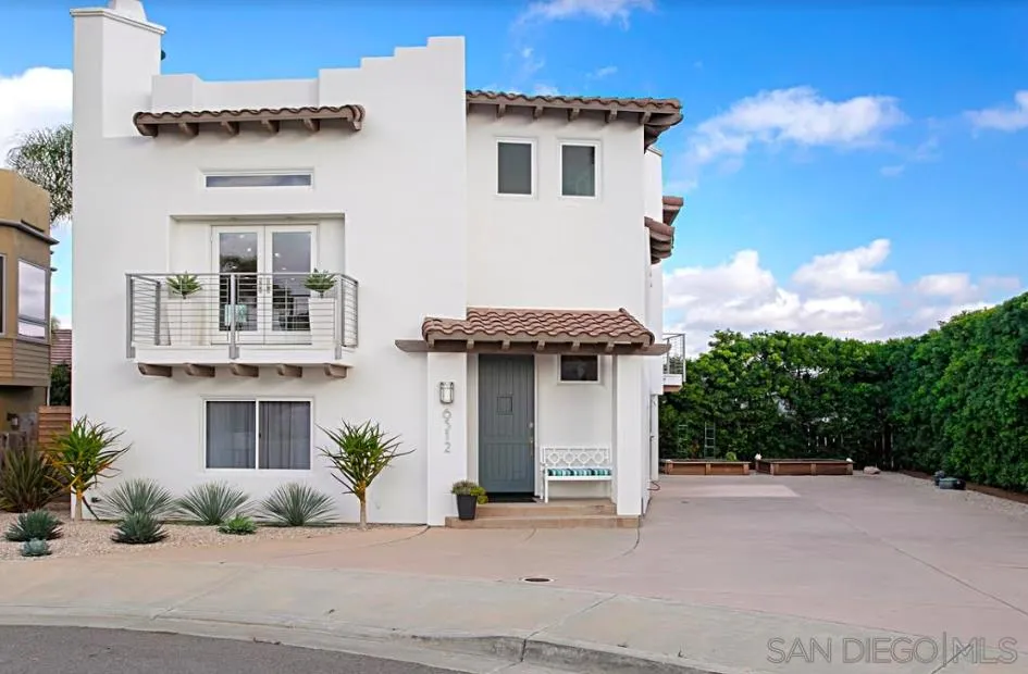 6512 Surfside Lane Carlsbad, CA 92011 - Photo 2 of 26 a front view of a house with a yard and garage