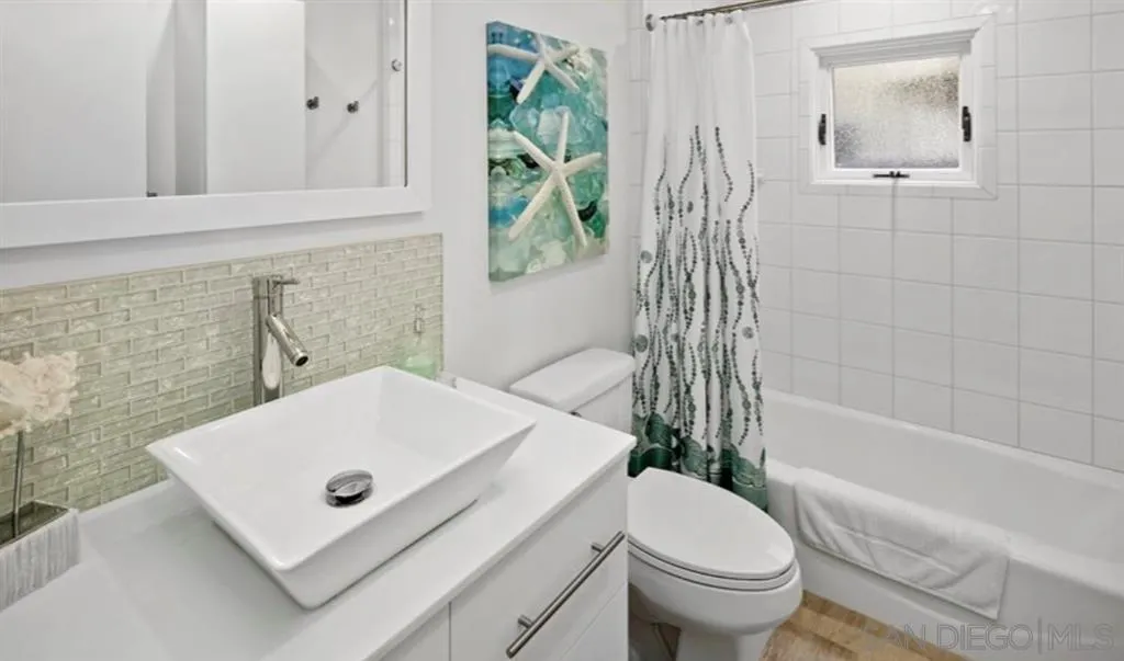 6512 Surfside Lane Carlsbad, CA 92011 - Photo 22 of 26 a bathroom with a sink a toilet and a bathtub