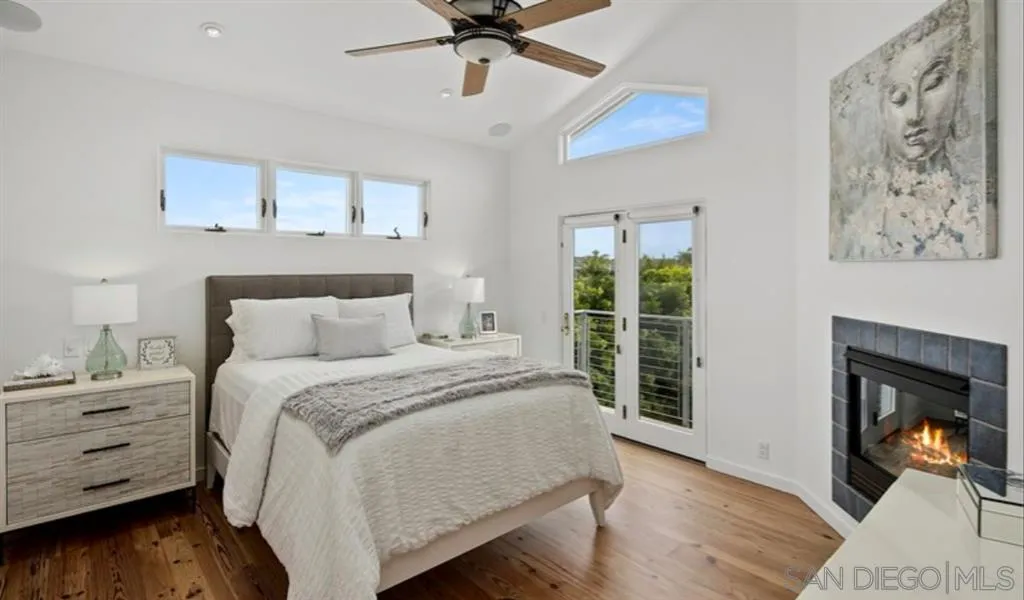 6512 Surfside Lane Carlsbad, CA 92011 - Photo 7 of 26 a bedroom with a bed and a fireplace