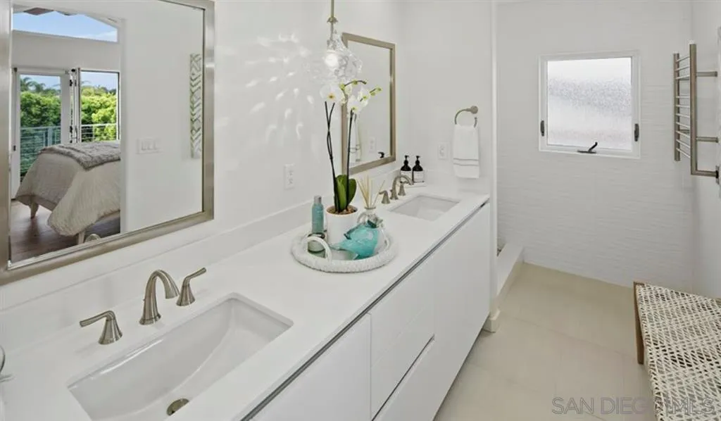 6512 Surfside Lane Carlsbad, CA 92011 - Photo 8 of 26 a bathroom with a sink and a mirror