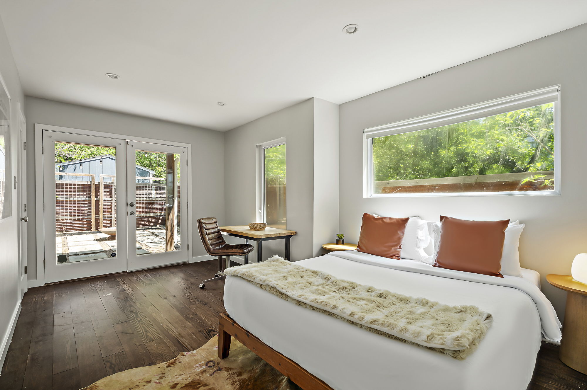 1211 Alexander Avenue Austin, TX 78702 - Photo 18 of 34 a bedroom with a bed and wooden floor