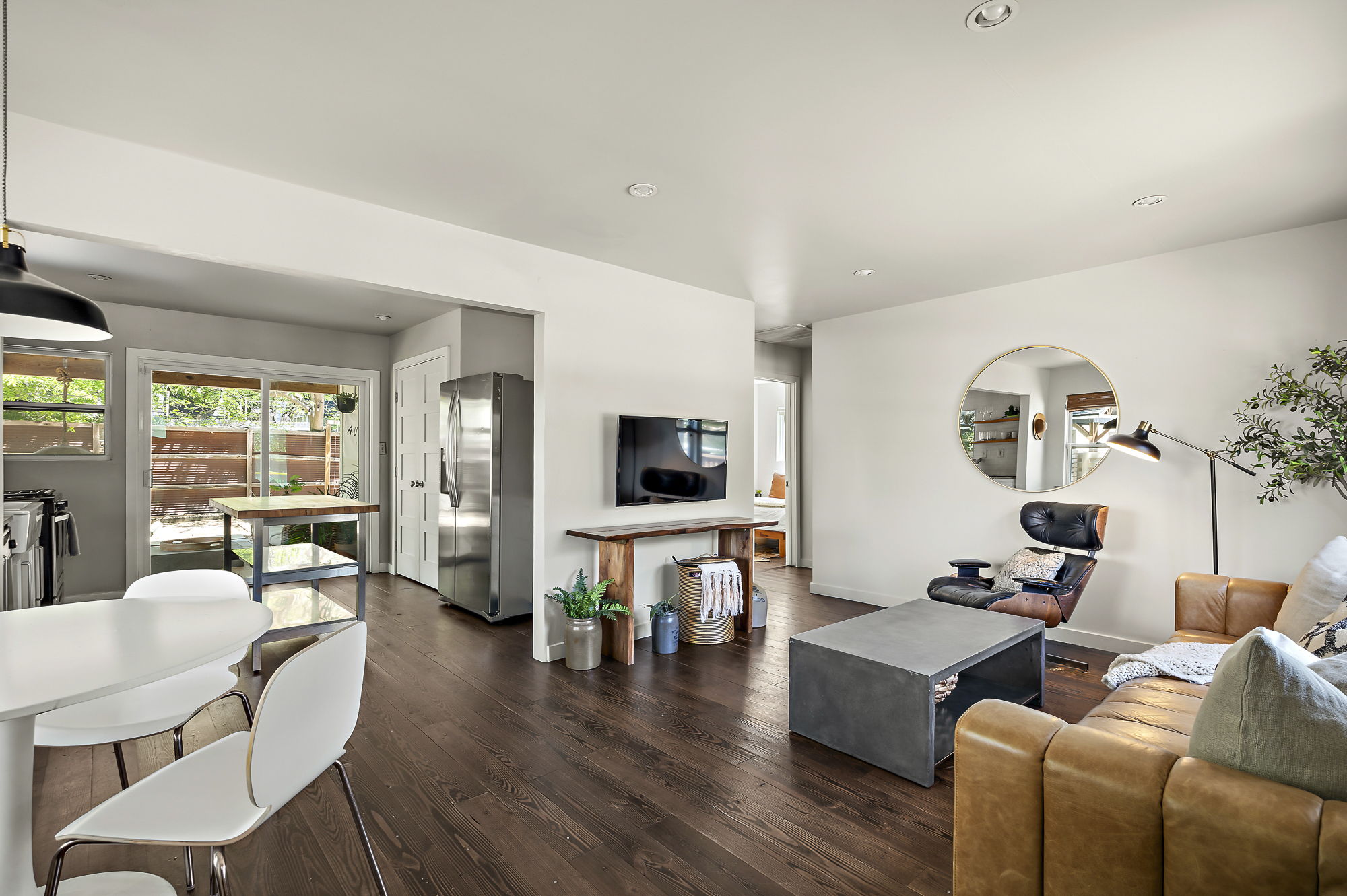 1211 Alexander Avenue Austin, TX 78702 - Photo 2 of 34 a living room with furniture a flat screen tv and wooden floor