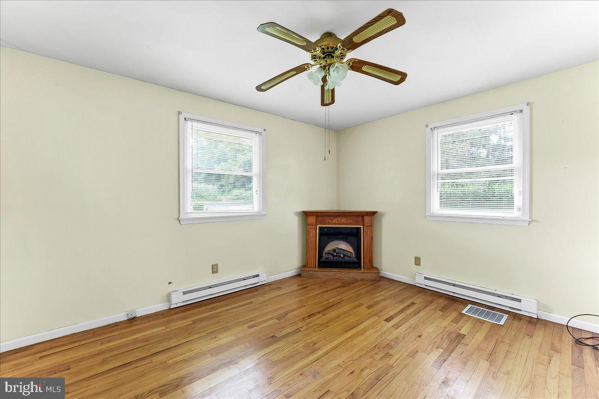 374 Street Road Cochranville, PA 19330 - Photo 12 of 28 a view of an empty room with a window and a fireplace