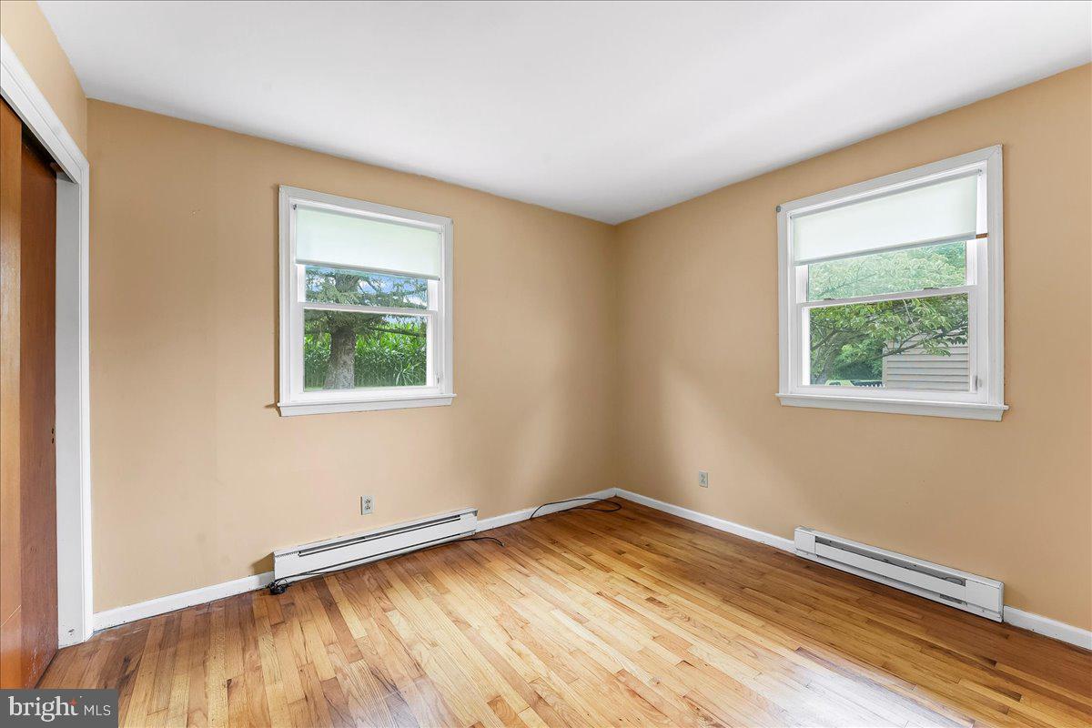 374 Street Road Cochranville, PA 19330 - Photo 14 of 28 wooden floor in an empty room with a window