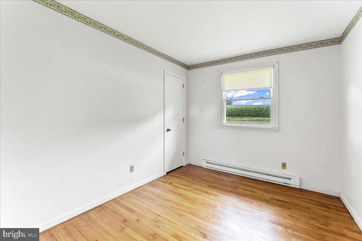 374 Street Road Cochranville, PA 19330 - Photo 15 of 28 a view of empty room with wooden floor