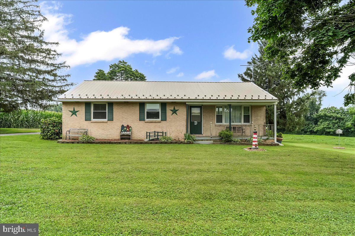 374 Street Road Cochranville, PA 19330 - Photo 2 of 28 a front view of a house with a garden