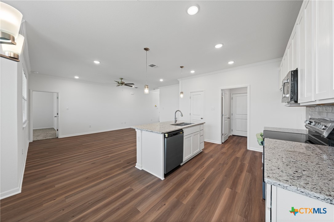 7906 Timber Holw Lane Temple, TX 76502 - Photo 18 of 29 a large kitchen with stainless steel appliances granite countertop a large counter top a sink and a stove