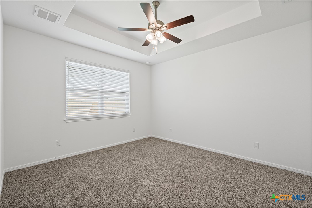 7906 Timber Holw Lane Temple, TX 76502 - Photo 22 of 29 an empty room with windows and fan