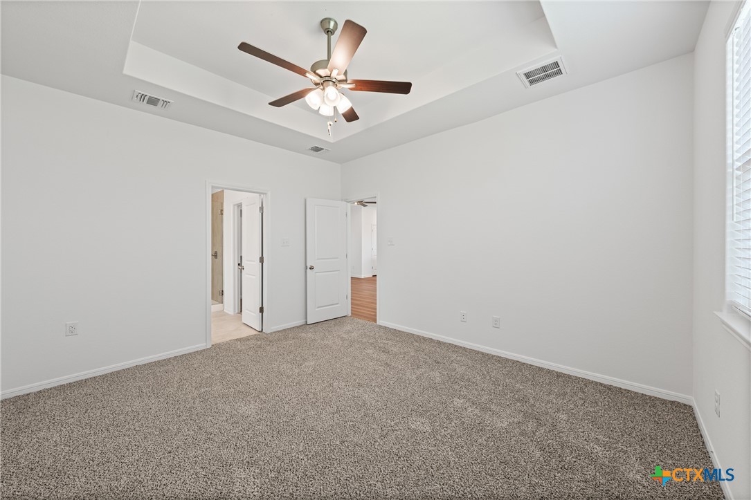 7906 Timber Holw Lane Temple, TX 76502 - Photo 23 of 29 an empty room with a chandelier fan and a large window