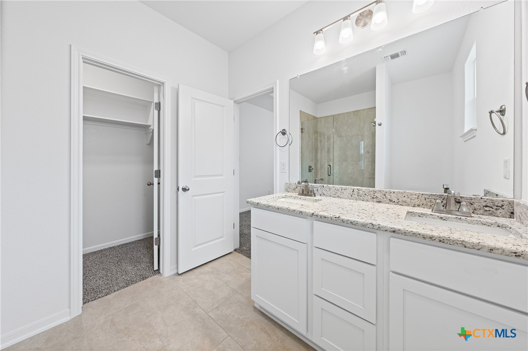 7906 Timber Holw Lane Temple, TX 76502 - Photo 25 of 29 a bathroom with a granite countertop sink and a mirror