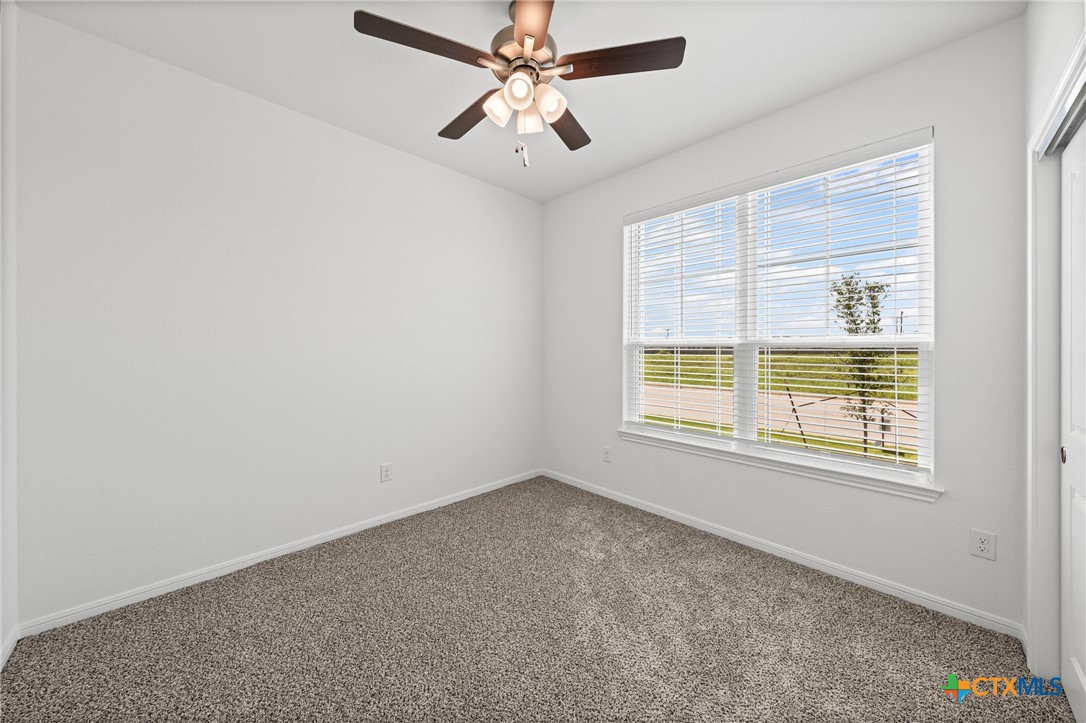 7906 Timber Holw Lane Temple, TX 76502 - Photo 7 of 29 an empty room with a window and a fan