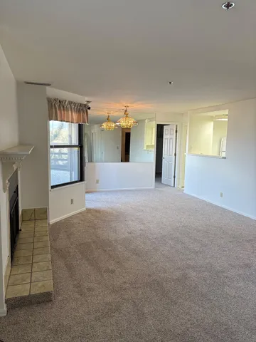 a view of a big room with windows and fireplace