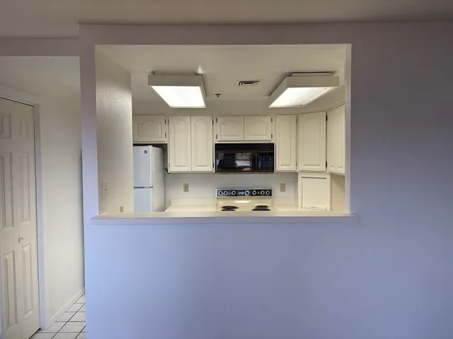 a kitchen with stainless steel appliances a sink a stove a microwave and cabinets