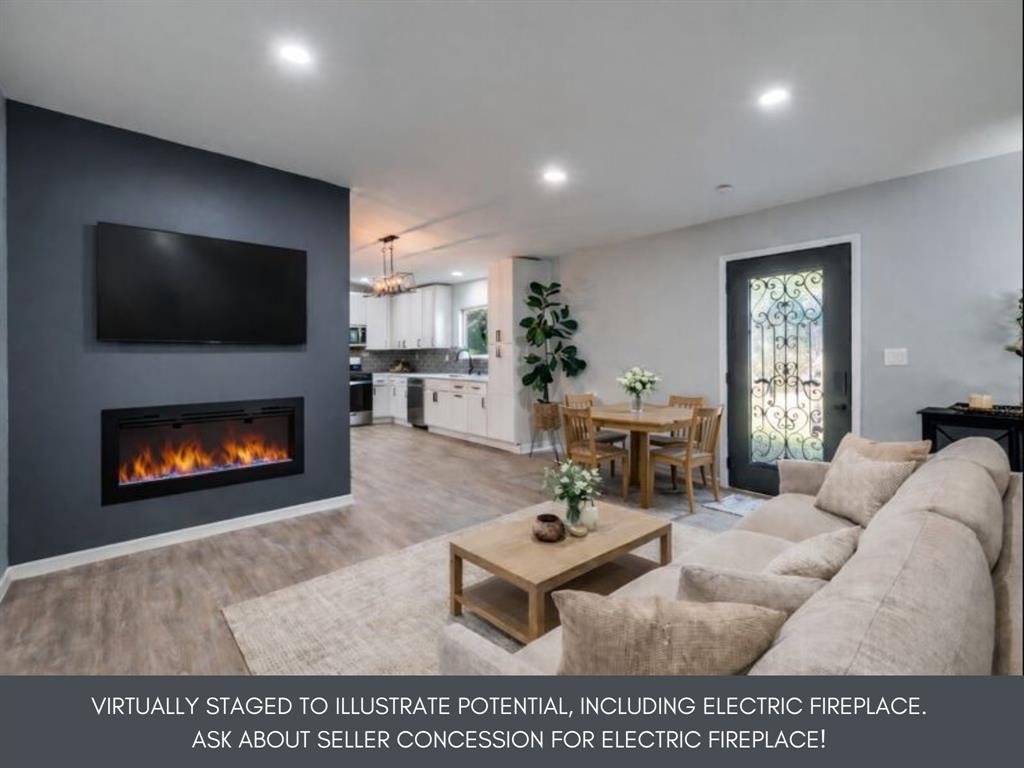 718 Glen Rhea Drive Lake Dallas, TX 75065 - Photo 3 of 23 a living room with furniture a flat screen tv and a fireplace