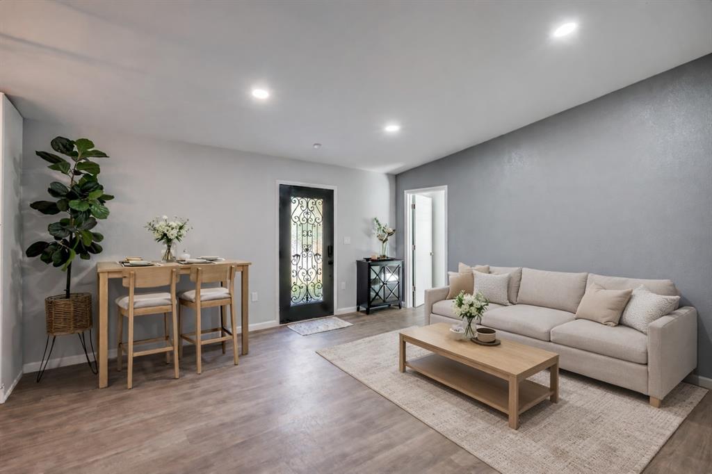 718 Glen Rhea Drive Lake Dallas, TX 75065 - Photo 8 of 23 a living room with furniture a wooden floor and a potted plant