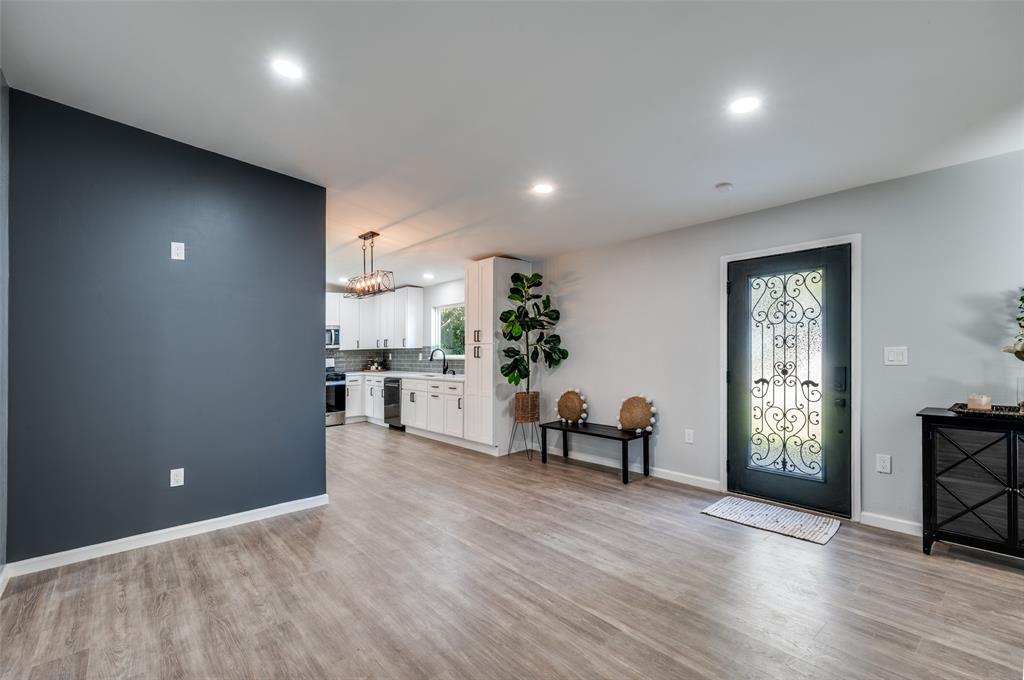 718 Glen Rhea Drive Lake Dallas, TX 75065 - Photo 9 of 23 an empty room with wooden floor and a window