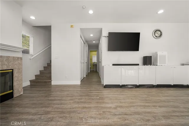a view of a livingroom with an empty space and a kitchen